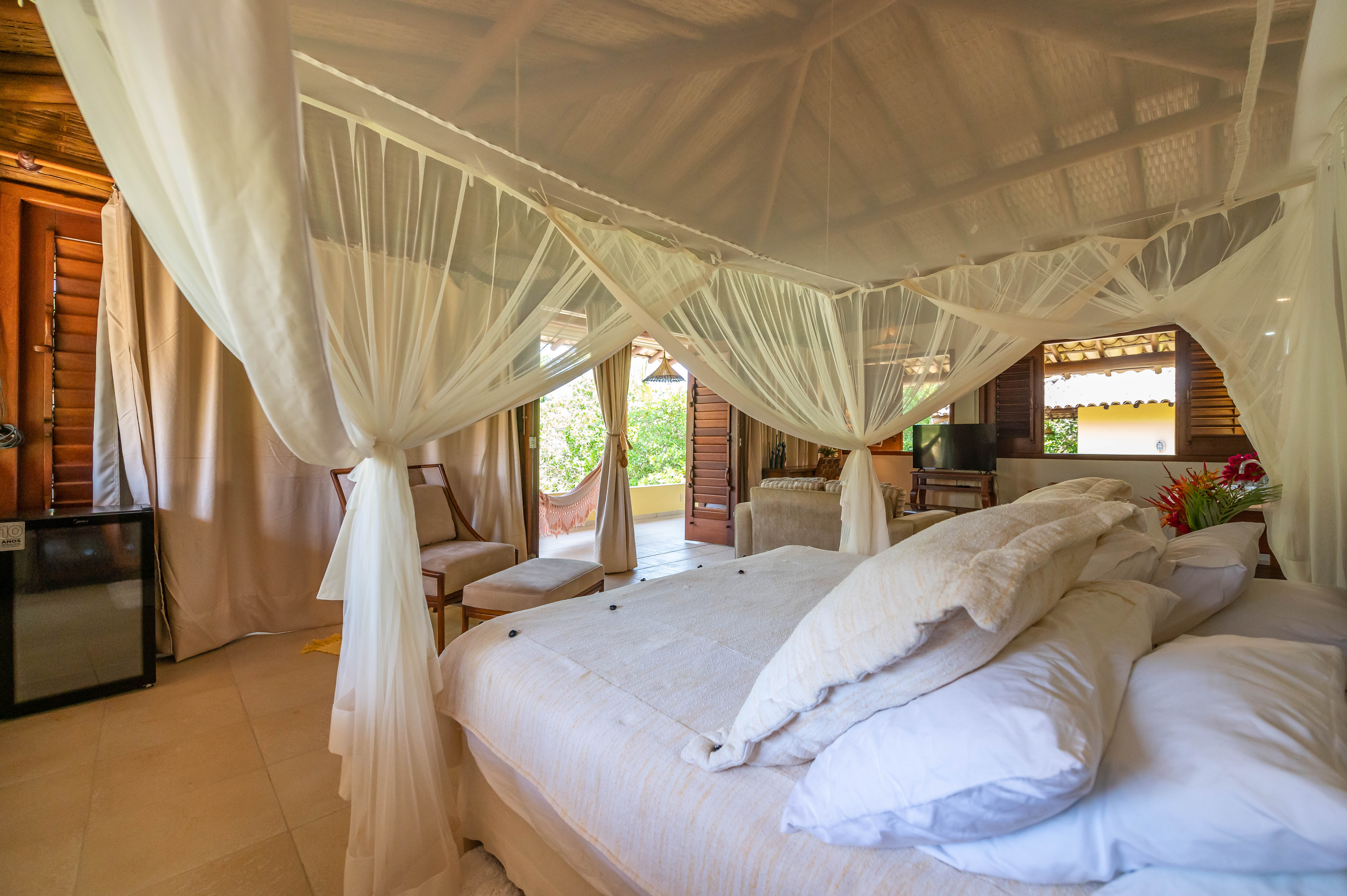 Cama king com dossel de mosquiteiro branco